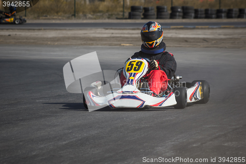 Image of Karting - driver in helmet on kart circuit