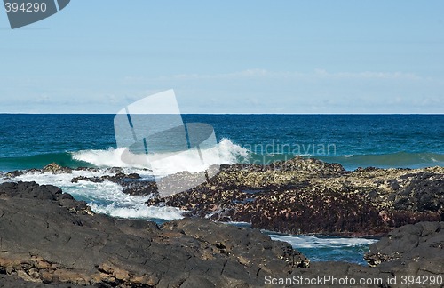 Image of waves breaking on the rocks
