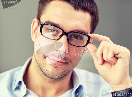Image of portrait of businessman in eyeglasses at office