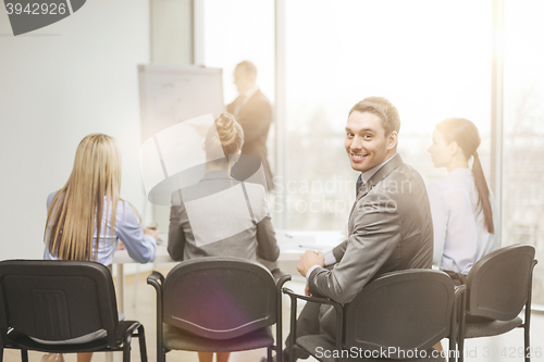 Image of businessman with team in office