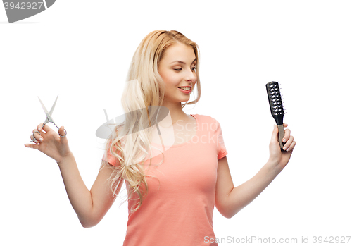 Image of young woman with scissors and hairbrush