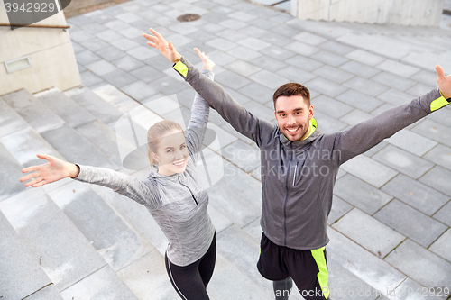 Image of happy smiling couple outdoors on city street