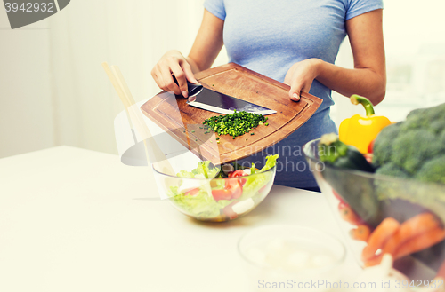 Image of close up of woman with chopped onion cooking salad