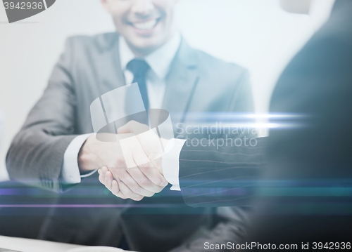 Image of two businessmen shaking hands in office