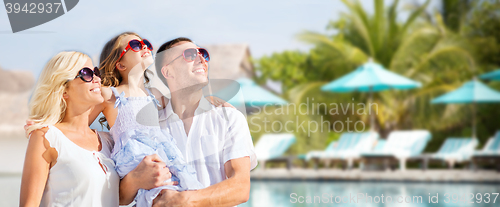 Image of happy family over hotel resort swimming pool