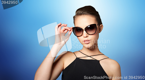 Image of beautiful young woman in elegant black sunglasses