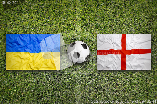 Image of Ukraine vs. England flags on soccer field