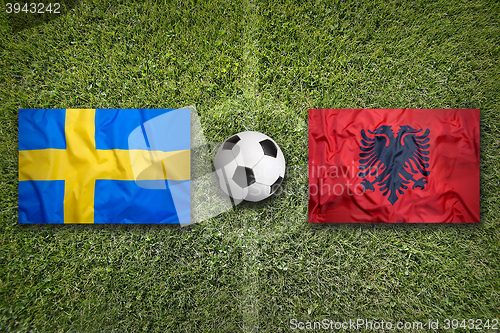 Image of Sweden vs. Albania flags on soccer field