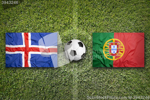 Image of Iceland vs. Portugal flags on soccer field