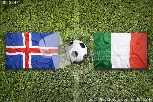 Image of Iceland vs. Italy flags on soccer field