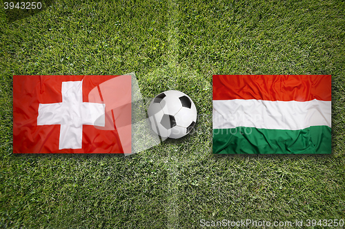 Image of Switzerland vs. Hungary flags on soccer field