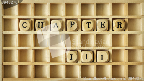 Image of wooden game with the word chapter three