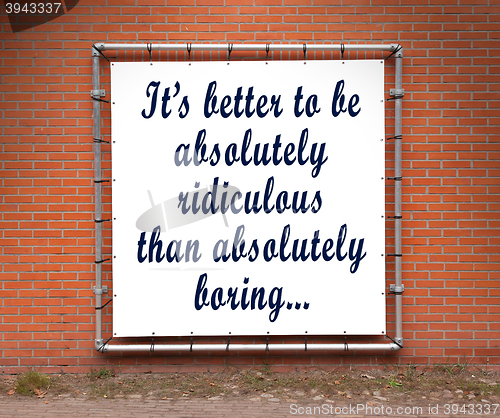 Image of Large banner with inspirational quote on a brick wall