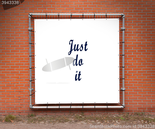 Image of Large banner with inspirational quote on a brick wall