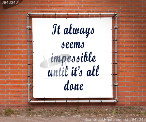 Image of Large banner with inspirational quote on a brick wall