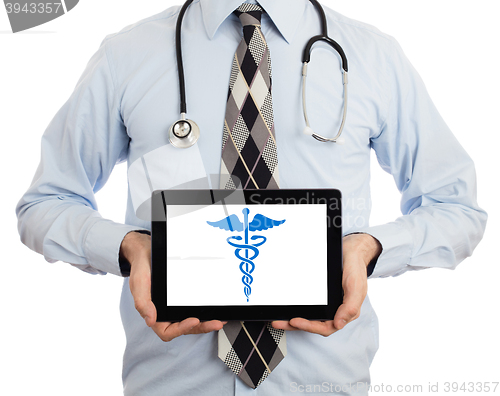 Image of Doctor holding tablet - Caduceus symbol