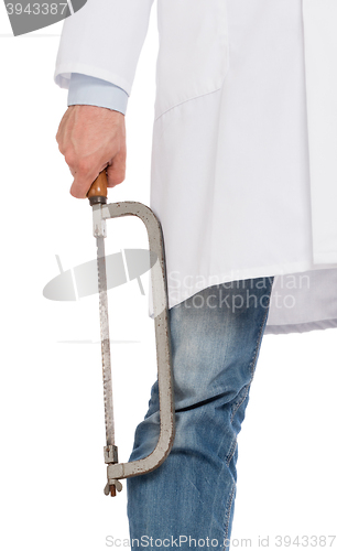 Image of Crazy doctor is holding a big saw in his hands