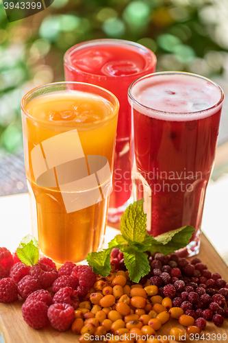 Image of fruit drink with cranberries raspberries and sea buckthorn