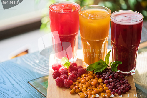 Image of fruit drink with cranberries raspberries and sea buckthorn