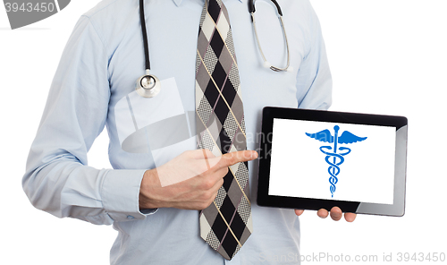 Image of Doctor holding tablet - Caduceus symbol