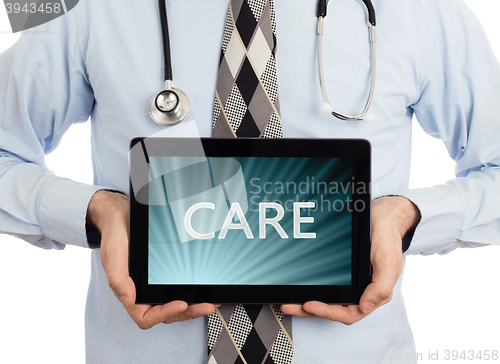 Image of Doctor holding tablet - Care