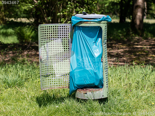 Image of Broken litter bin in the park