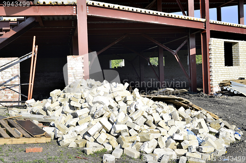 Image of Construction materials and waste on the background of building under construction