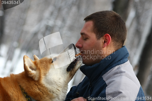 Image of Man with dog and cracker