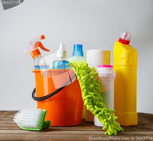 Image of Bucket with cleaning items on light background