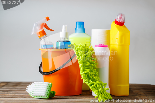 Image of Bucket with cleaning items on light background