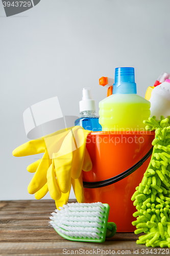 Image of Bucket with cleaning items on light background