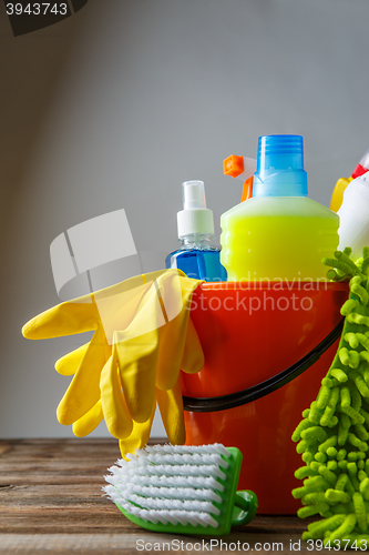 Image of Bucket with cleaning items on light background