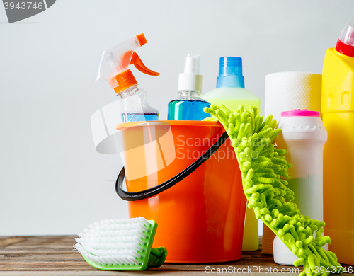 Image of Bucket with cleaning items on light background