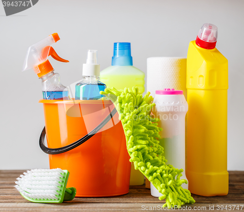 Image of Bucket with cleaning items on light background