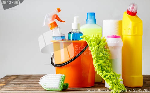 Image of Bucket with cleaning items on light background