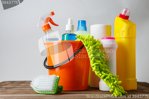 Image of Bucket with cleaning items on light background