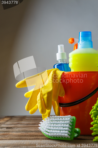 Image of Bucket with cleaning items on light background
