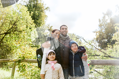 Image of happy family with backpacks hiking