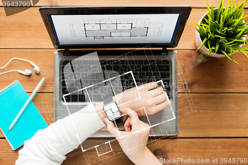 Image of close up of woman with smart watch and laptop