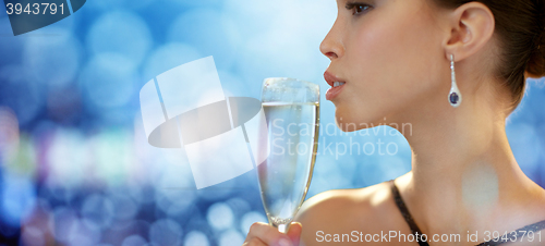 Image of close up of woman drinking champagne at party