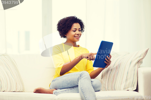 Image of happy african american woman with tablet pc