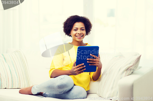 Image of happy african american woman with tablet pc