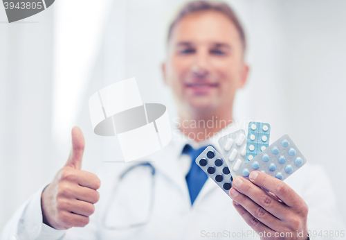 Image of male doctor with packs of pills