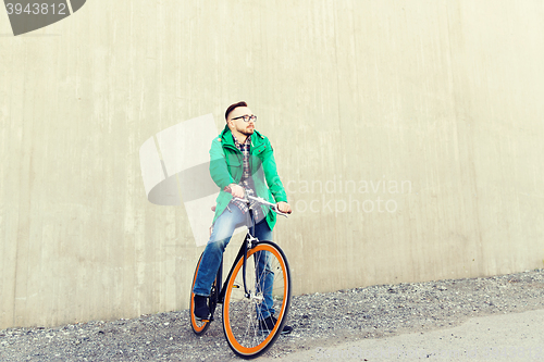 Image of happy young hipster man with fixed gear bike