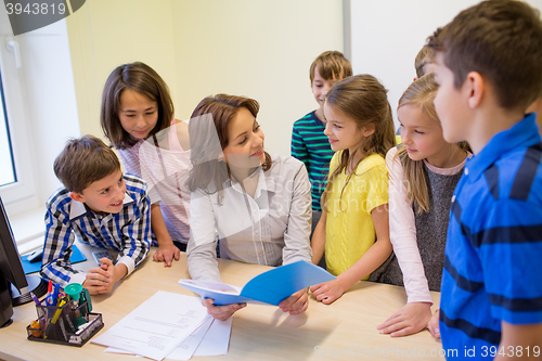 Image of group of school kids with teacher in classroom