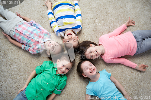 Image of happy smiling little children lying on floor