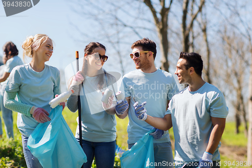 Image of volunteers with garbage bags cleaning park area