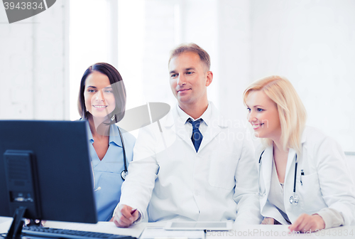 Image of doctors looking at computer on meeting