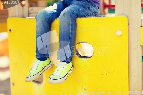 Image of close up of boy legs on children playground