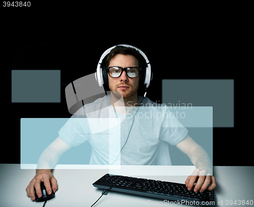 Image of man in headset playing computer video game